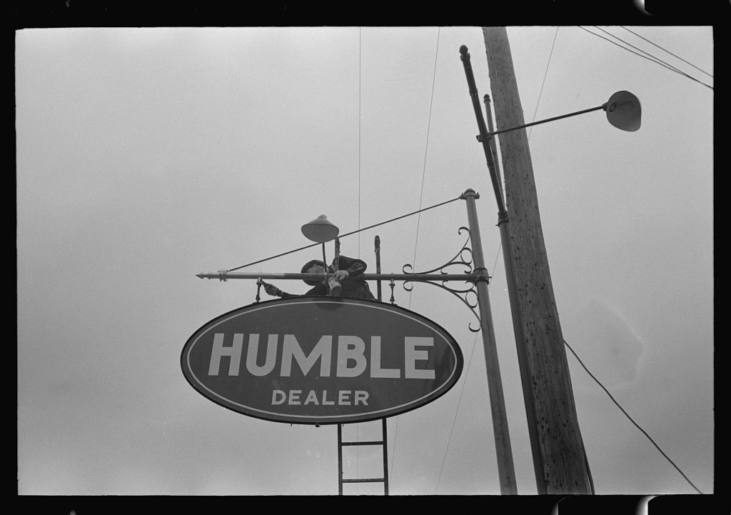 Man erecting sign near Alice, Texas