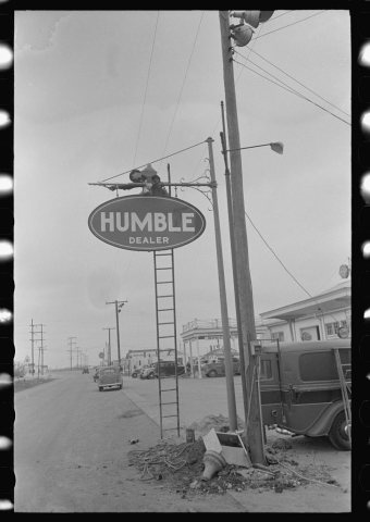 Man erecting sign near Alice, Texas