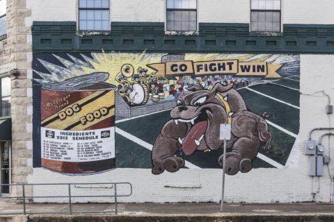 Creative display of the local high school's football team schedule on a building in little McGregor in McLennan County,…
