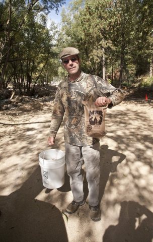 Jamestown, Colo., October 9,2013--A resident of Jamestown, CO holds up a packet of Meal Ready to Eat (MRE) which are be…