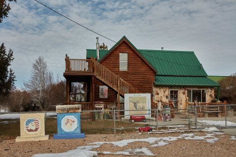 Welcome signs with outdoor themes dominate the decorations outside a modest home in the little town of Sterling in sout…