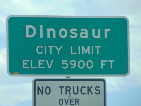 Dinosaur city limit sign