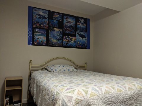 Bedroom with marine puzzles on wall