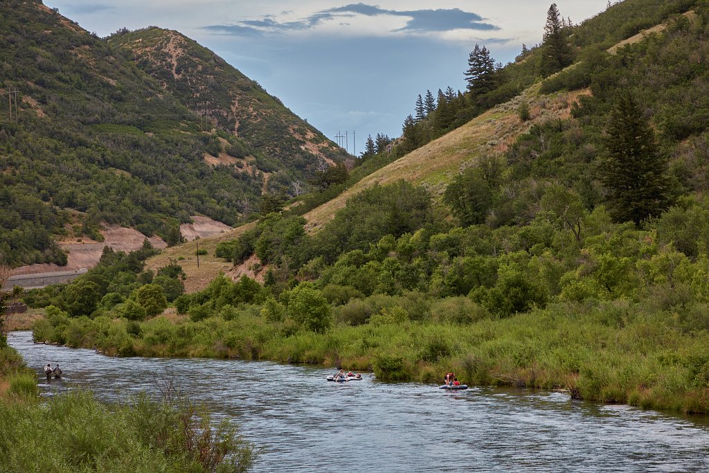 Both fishermen (left) and rafters enjoy the wonders of the Provo River in Provo Canyon, near Orem, Utah
