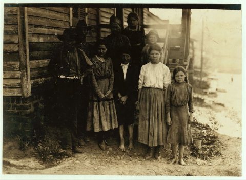 Family of J. J. Moore. All but mother and two smallest children on steps work in Washington Cotton Mills