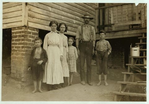 T.J. Fields and family. The father cards, two girls spin, boy on right end picks up bobbins, Washington Cotton Mills