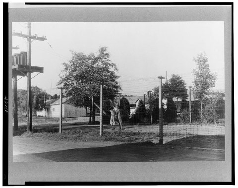 Barbed wire-enclosed barracks for migratory labors at Webster Canning Company