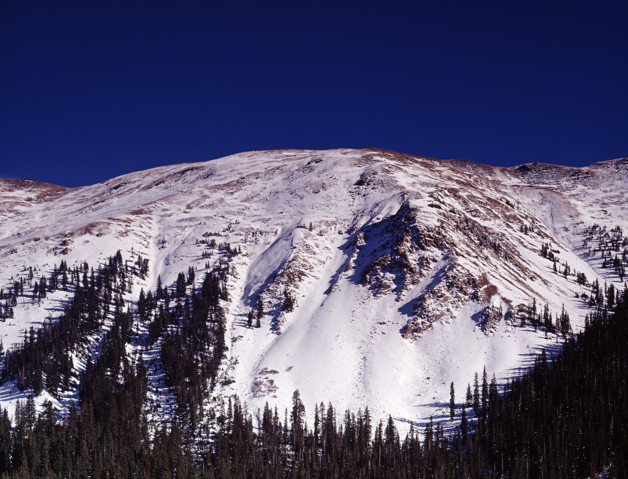 Snowy Rocky Mountain peak above