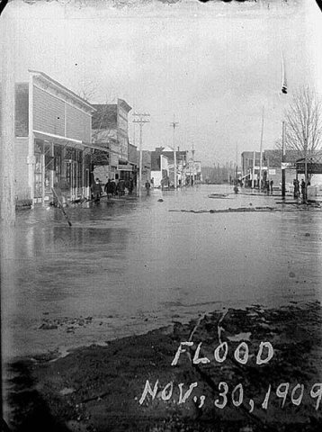 Flooded street from Nooksack River, Sumas, November 30, 1909
