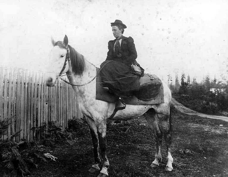May Johnson on a horse delivering the mail, Washington, 1898