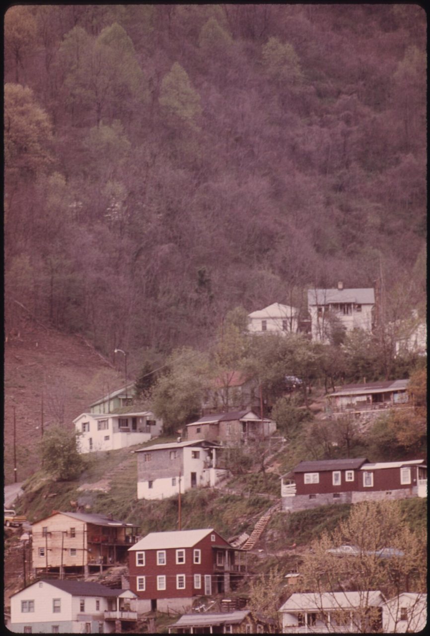 HOUSES PERCHED ON A HILLSIDE IN LOGAN, WEST VIRGINIA. MANY HOMES ARE BUILT ON HILLY GROUND BECAUSE FLAT LAND IN THE... …