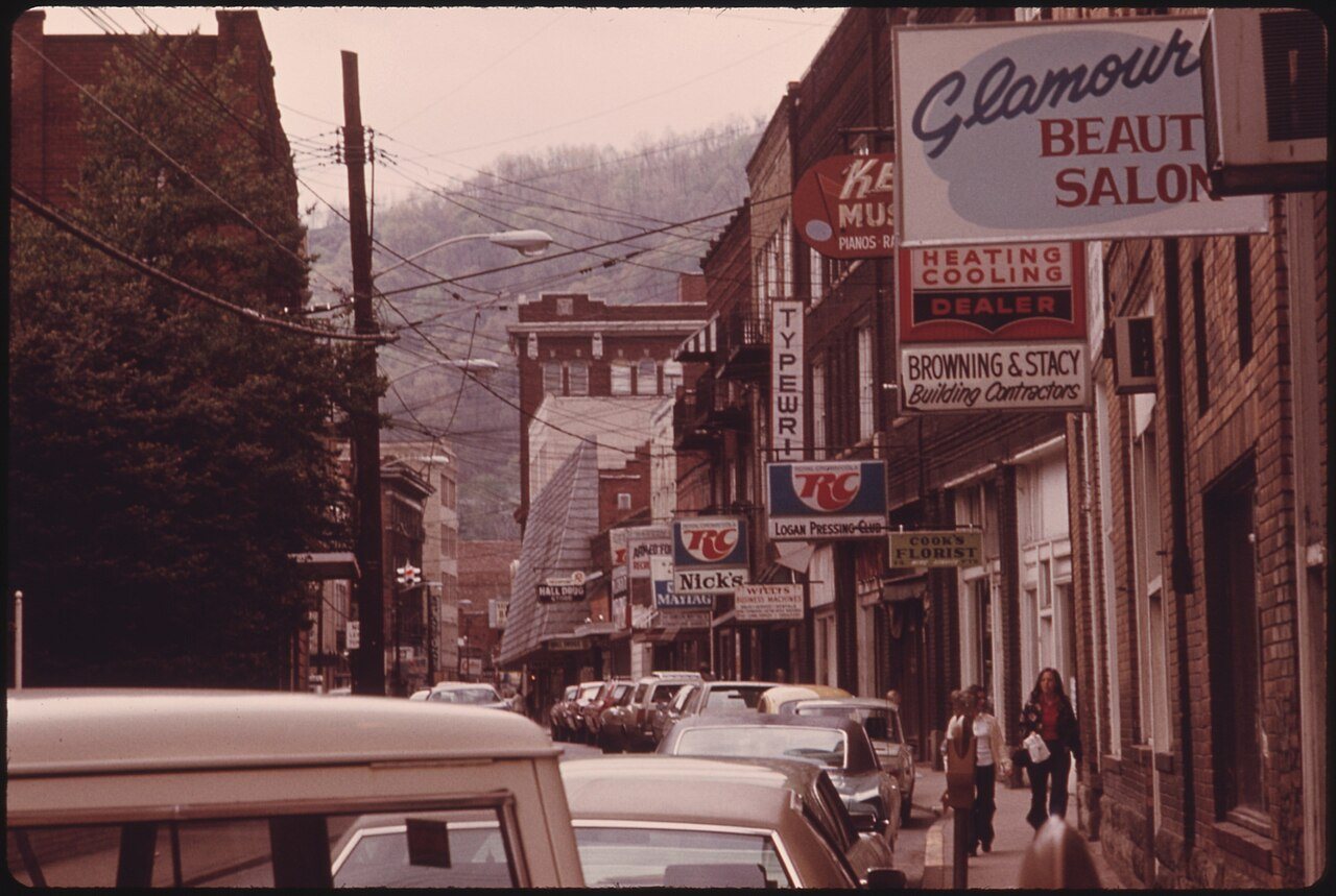 MAIN STREET OF LOGAN, WEST VIRGINIA, SHOWING A NARROW STREET WITH PARKING ON ONLY ONE SIDE WHICH IS TYPICAL IN MANY... …
