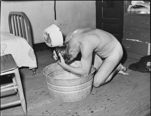 Milong Bond, tipple worker, taking a bath. There is no washhouse for mine nor tipple workers. Mullens Smokeless Coal...…