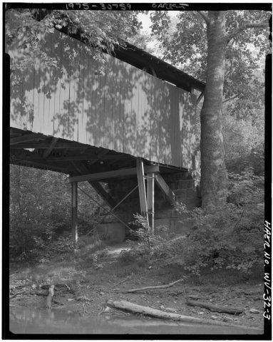 DETAIL VIEW OF END OF BRIDGE, SHOWING NEW STEEL BEAM AND COLUMNS AND ORIGINAL STONE ABUTMENT - Milton Covered Bridge, C…