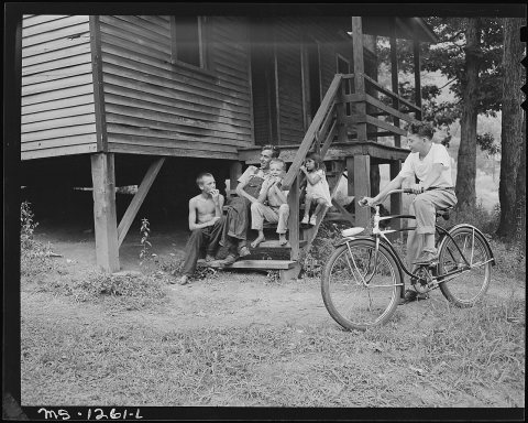 A miner and children on steps of a typical house. Kingston Pocahontas Coal Company, Exeter Mine, Big Sandy Housing... -…