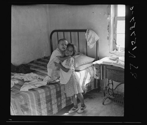 A girl of six who has full charge of her boy brother. Great Western Sugar Company's beet sugar workers' colony at Hudso…