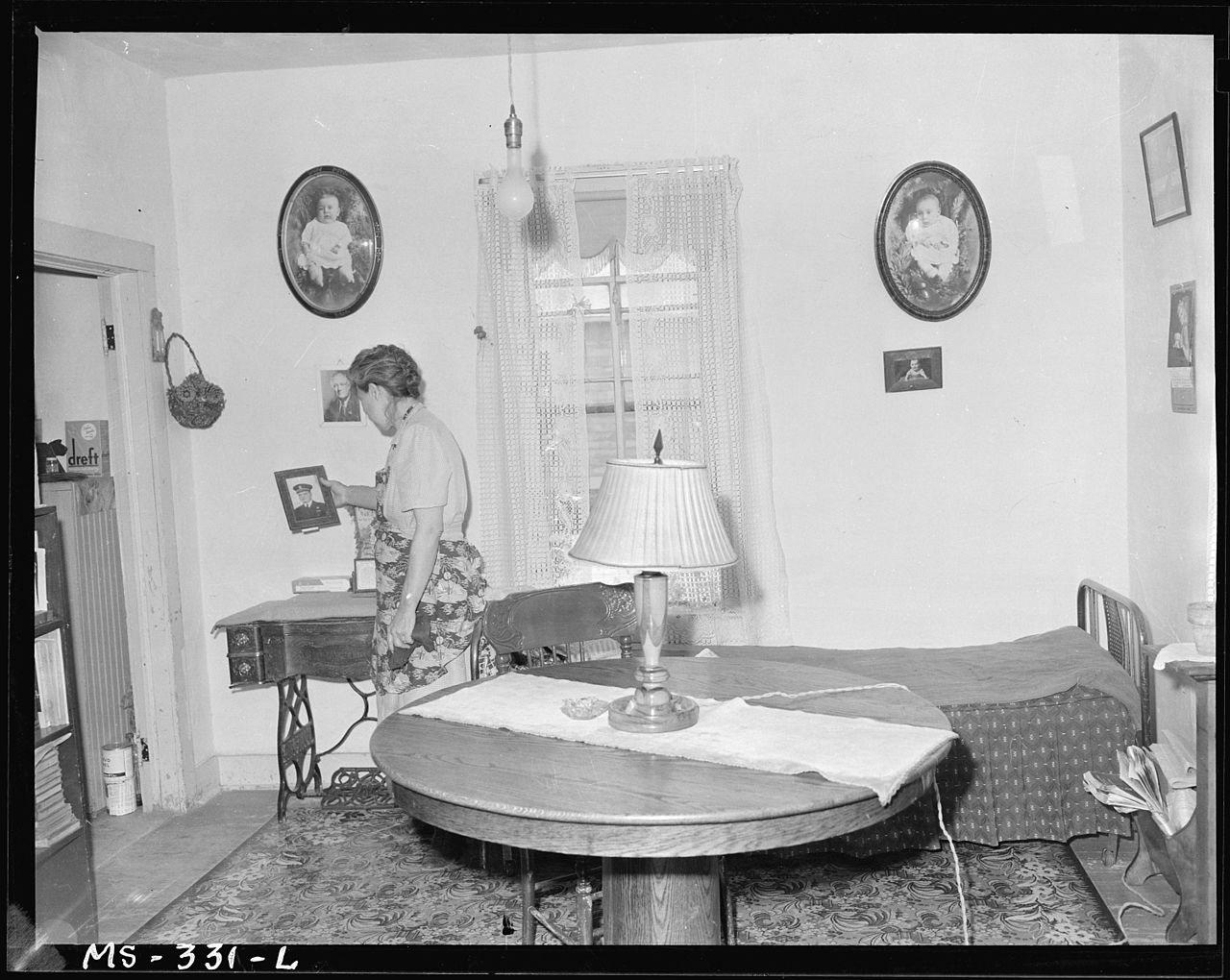 Mrs. Molly Genoff, wife of miner in living room of her home. Puritan Camp, Erie, Colorado