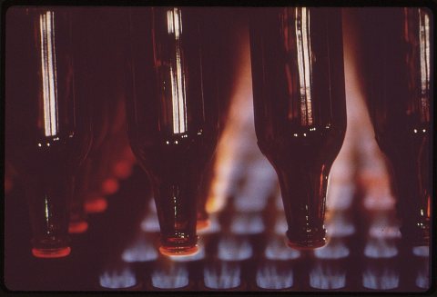 RECYCLED BEER BOTTLES RECEIVE HEAT TREATMENT PRIOR TO FINAL PACKAGING. ONE PART OF A NEW GLASS RECYCLING PROCESS FOR...…