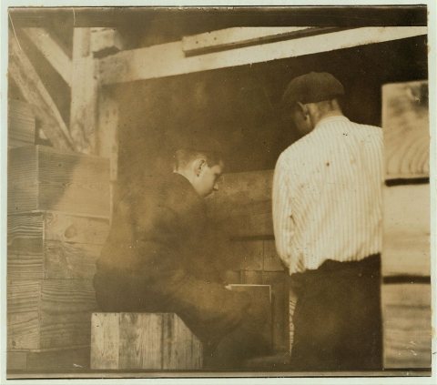 2 boys at the filling machine in Cannon's Cannery