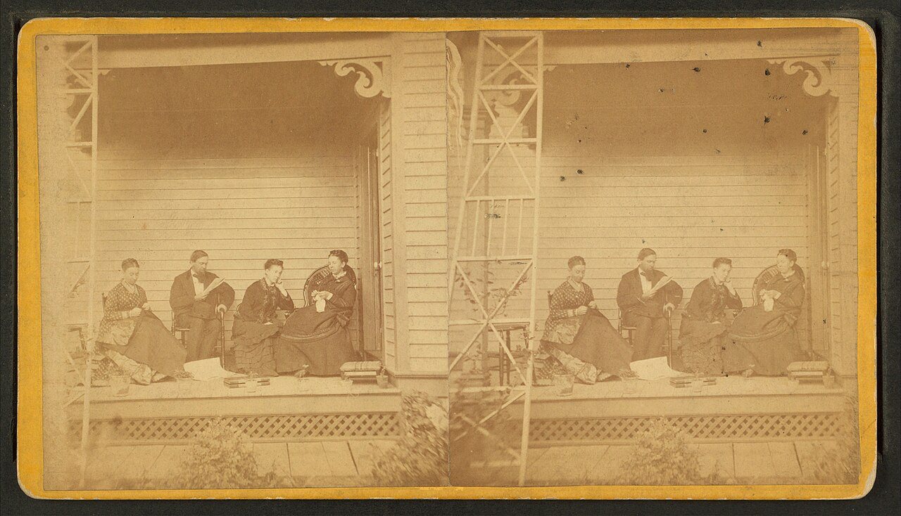 Scene on porch of house of C. C. Merrill. Galesburg, Ill.Alternate Title: Group reading and sewing on the porch of C. C…