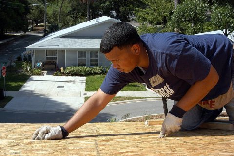 US Navy 060519-N-6645H-073 Airman Daniel Akinduro helps construct a house for Beaches Habitat