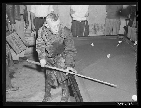 Construction worker playing pool. Starke, Florida