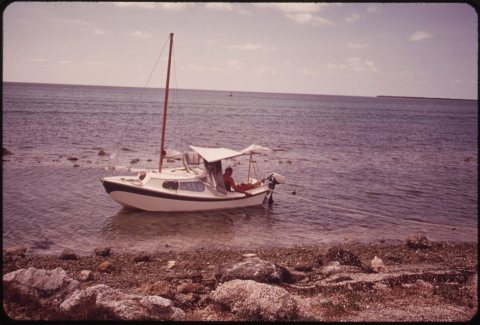 RESTING BOATER IDLES HIS CRAFT IN A LAGOON AT MARATHON IN THE CENTRAL FLORIDA KEYS