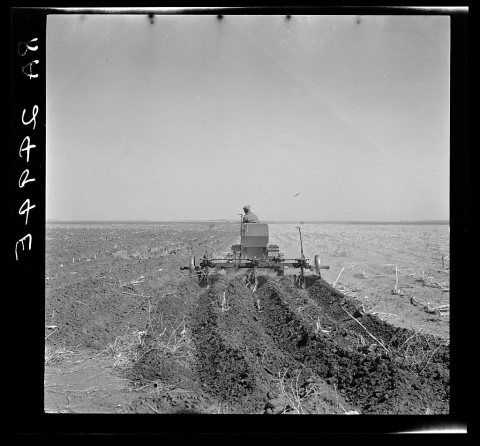 A farmer listing his fields under the wind erosion control program. He receives twenty cents an acre for the work. Libe…