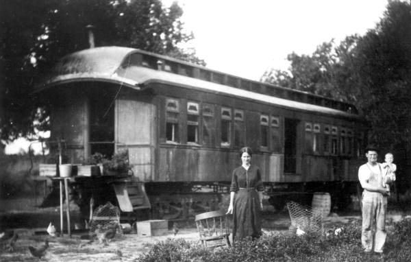 Family using a railroad car of the Tavares and Gulf Railroad as a home