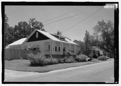 View of 501 8th St., a side-gable duplex bungalow with engaged porch and paired and clustered columns. Built as worker …