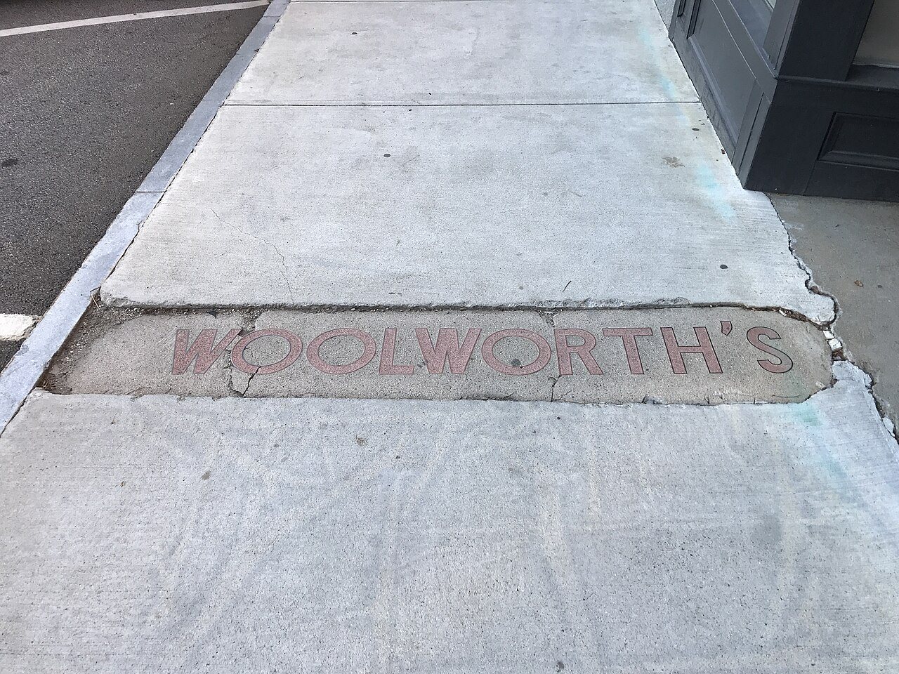 Woolworths sign in sidewalk