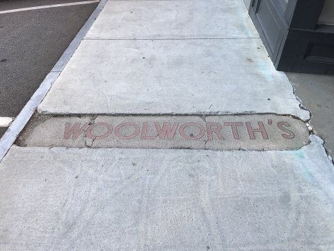 Woolworths sign in sidewalk