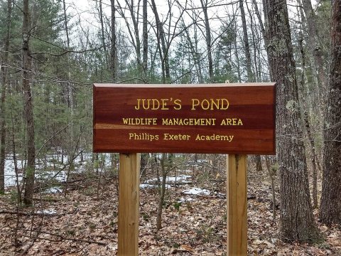 Judes pond sign Exeter NH, near memorial at water's edge