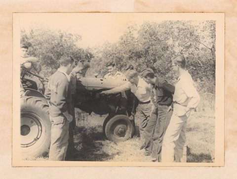 Photograph of vocational agriculture students learning about tractor operation and maintenance from an instructor, Sylv…