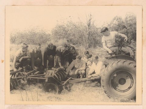 Photograph of vocational agriculture students learning about tractor operation and maintenance from an instructor, Sylv…