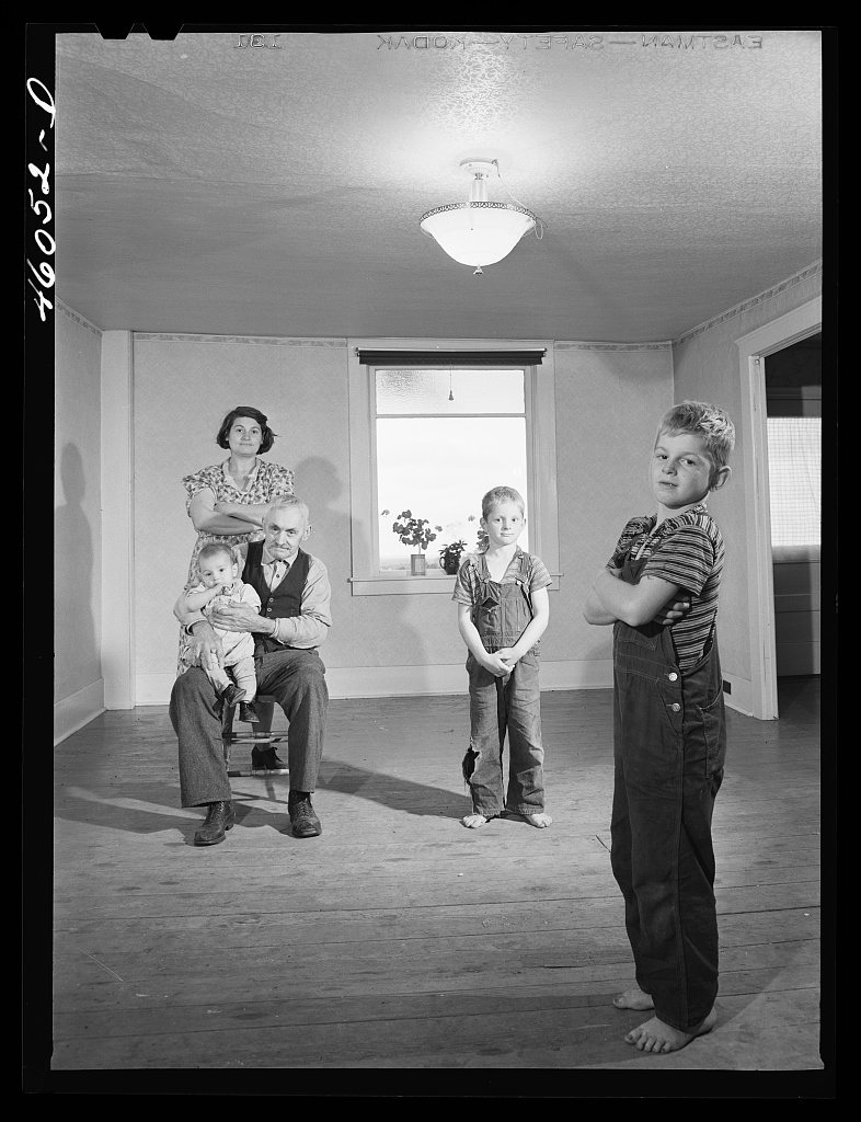 Mrs. Melvin Rivers, some of her children and her father-in-law in their new New York relocation corporation farm to whi…