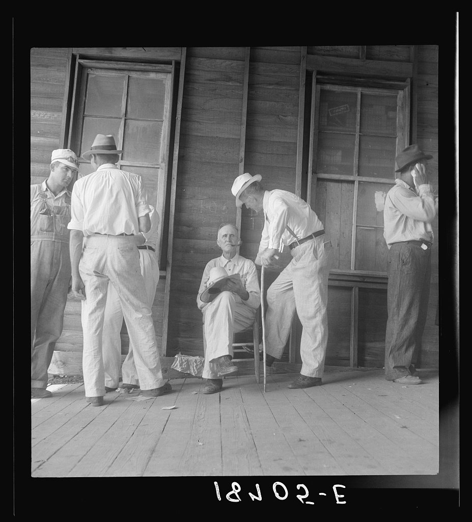 Douglas, Georgia. Farmers at tobacco auction. Common question is "What will it bring this year?"