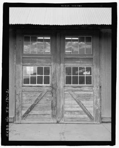AFRD WAREHOUSE, SOUTH SIDE DETAIL, SLIDING DOORS. FACING NORTH. COMPARE WITH FIGURES 4 AND 5 IN NARRATIVE REPORT, WHICH…