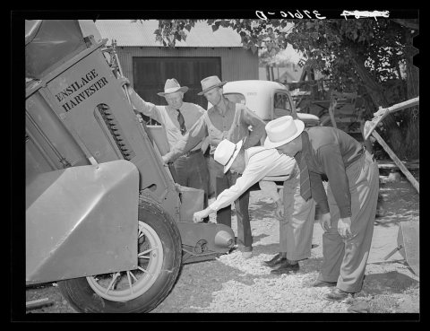 Committee of Cornish, Utah, corn machinery cooperative looking over ensilage harvester. Preston, Idaho