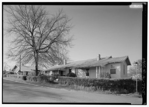 OBLIQUE VIEW, TCI DOUBLE THREE-ROOM HOUSE WITH STEEL ROOF AND ORIGINAL HEDGING AND CURB AND GUTTER ALONG ENGLAND AVENUE…