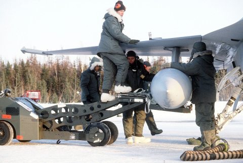 Ground crewman install an external wing fuel tank onto an F-16 Fighting Falcon aircraft assigned to the 388th Tactical …