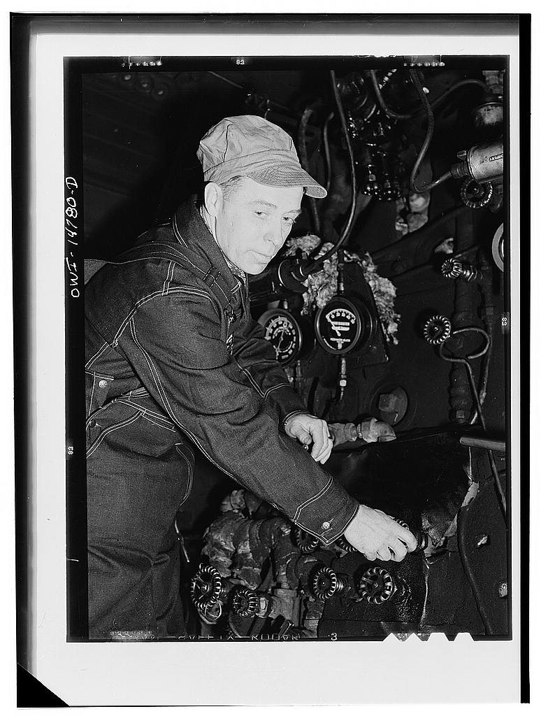 Hammond, Illinois. Switchman riding a car in an Illinois Central Railroad classification yard