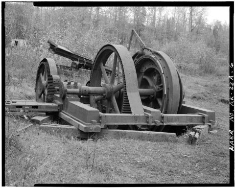 OBLIQUE VIEW OF HOIST, SHOWING WOODEN BRAKE SHOES, REDUCTION GEARS AND BED FOR (MISSING) CLUTCH-DRIVE GEAR UNIT, LOOKIN…