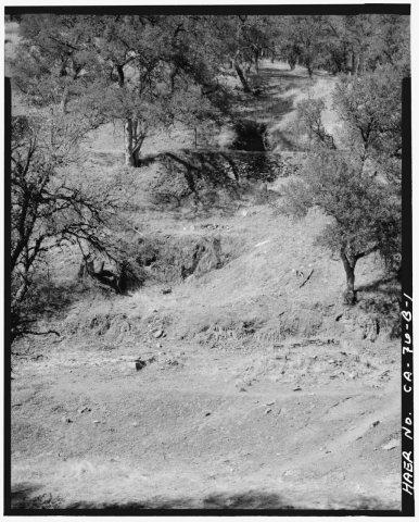 VIEW, LOOKING NORTHEAST, SHOWING THE SITE OF THE EMPIRE MILL. THE ADIT IS AT TOP, ABOVE THE TERRACES FOR THE CRUSHER AN…