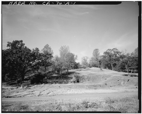 VIEW, LOOKING WEST, AT THE SITE OF THE PINE LOG MILL. THE STONE RETAINING WALL ON THE RIGHT MARKS THE LOCATION OF THE 1…