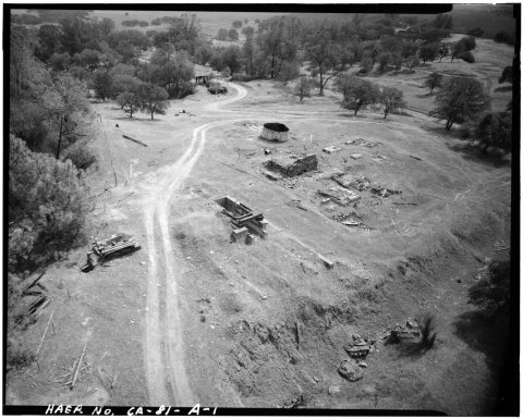 VIEW SHOWING FOUNDATIONS OF HOISTING WORKS, ROYAL MINE, 1988, LOOKING SOUTHEAST. GLORY HOLE DROPS OFF TO LEFT, AND EXCA…