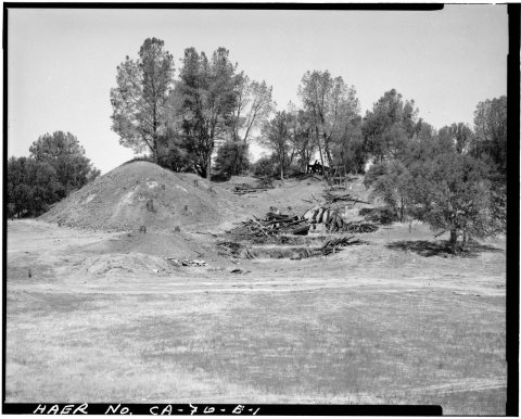VIEW, LOOKING FROM THE EAST, OF THE GOLD KNOLL SITE. MILL FOUNDATIONS ARE AT CENTER, WITH REMAINS OF THE TRESTLE ABOVE.…