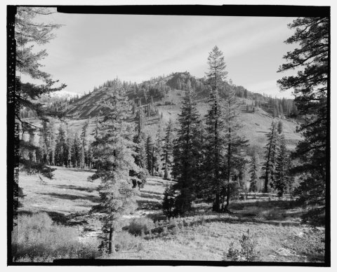 LASSEN LANDSCAPE VIEW FROM DECK OF CHALET AT SOUTH ENTRANCE. NOTE ROAD TRAVERSES AT UPWARD DIAGONAL ON FAR RIDGE. LOOKI…