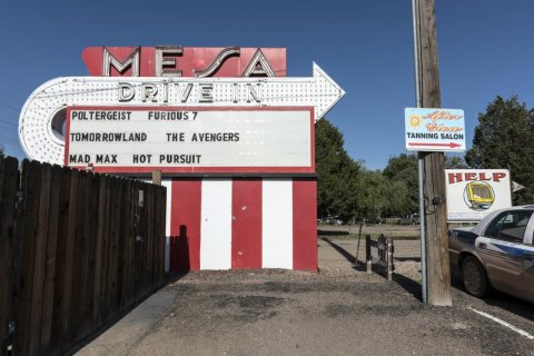 An array of signs, including the entryway neon of the Mesa Drive-in Theater, established in 1951