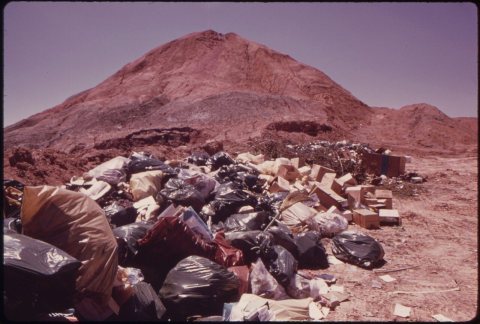 ABANDONED MINE IN LADD IS USED AS CITY DUMP. THE GARBAGE IS COVERED WITH CLAY